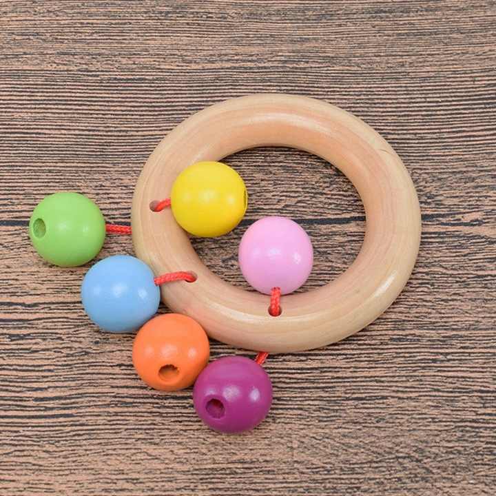 Wooden hand bell toy for toddlers with a safe and intelligent educational handle.