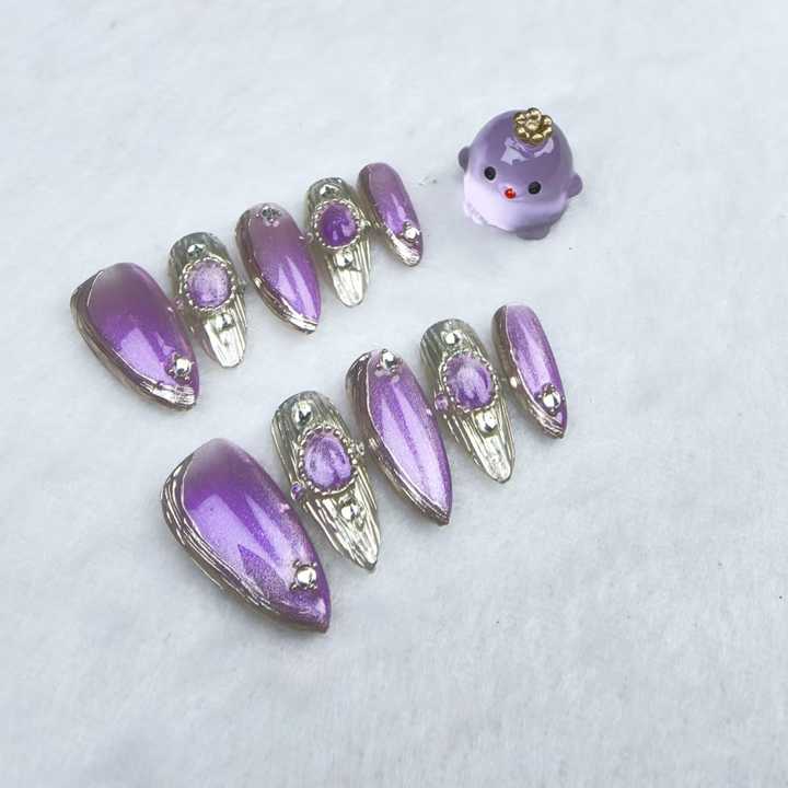 Handmade almond-shaped nails in purple 