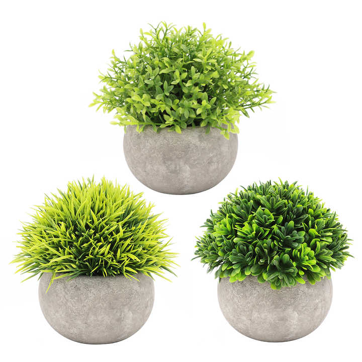 Small artificial plants in plastic pots. 