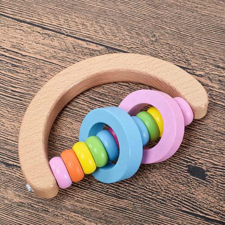 Wooden hand bell toy for toddlers with a safe and intelligent educational handle. 